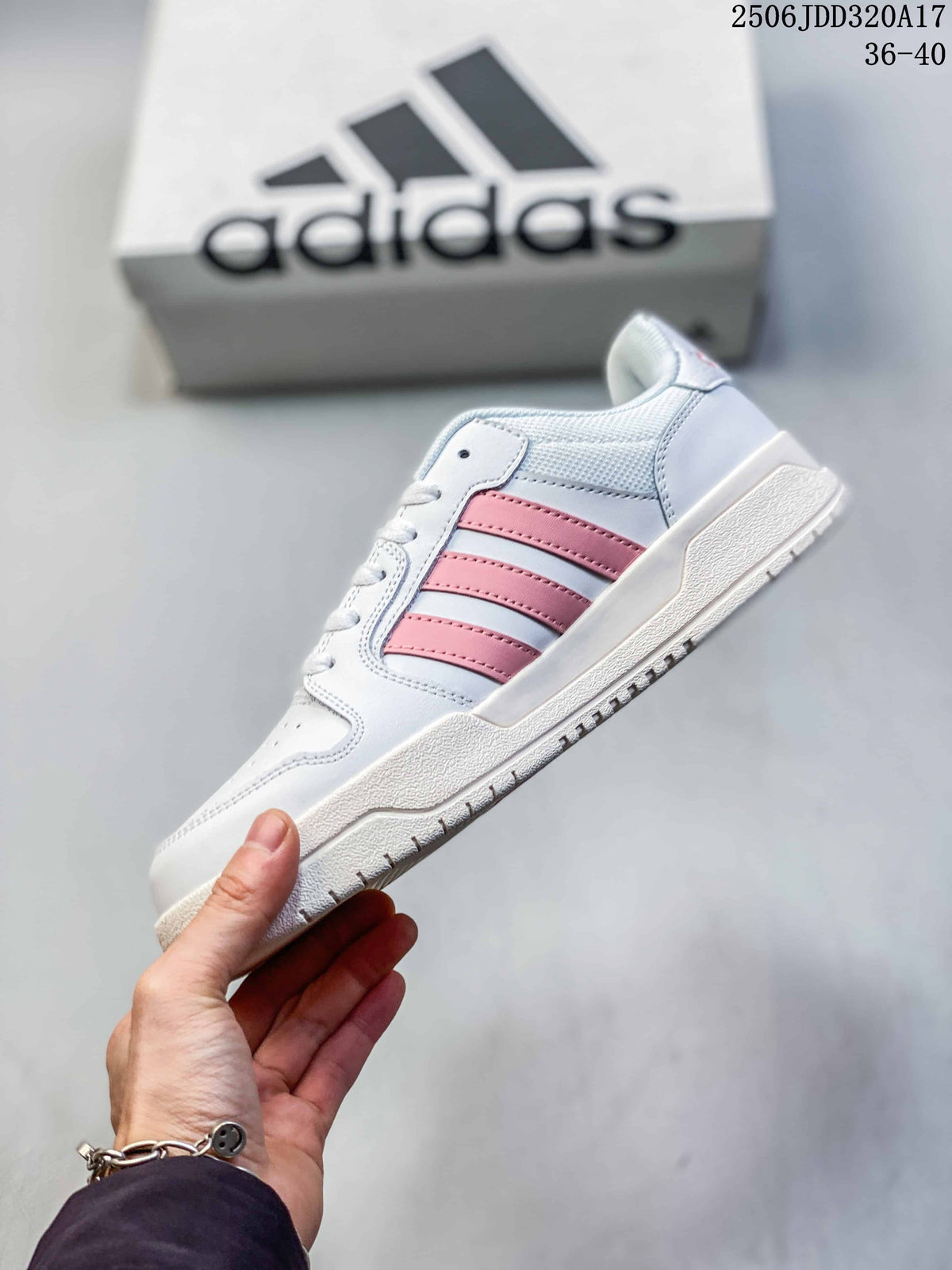Side profile of the adidas Entrap sneaker with pink stripes, white upper, and layered sole.
