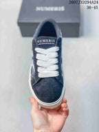Top view showing the navy toe, white laces, and NUMERIS branding on the tongue
