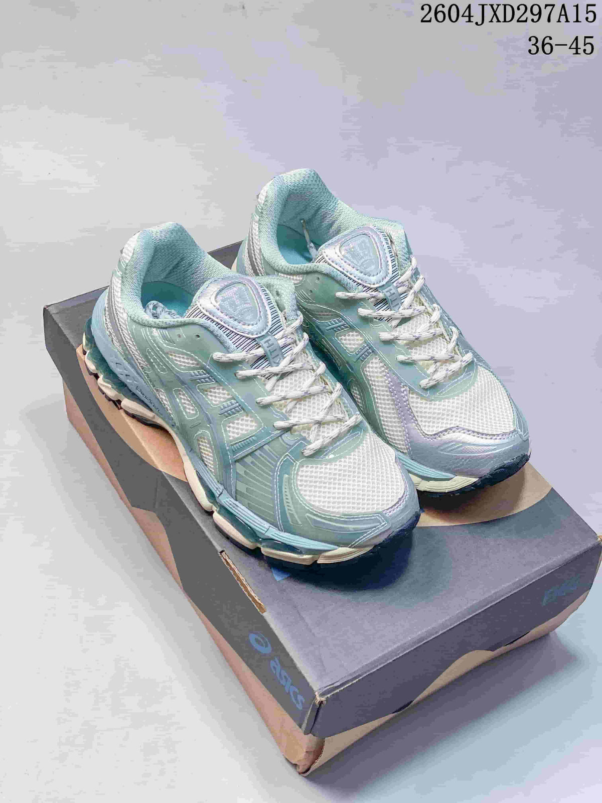 Pair of pale sage, white and lavender Kith x ASICS Gel-Kayano 12.1 sneakers on a shoebox