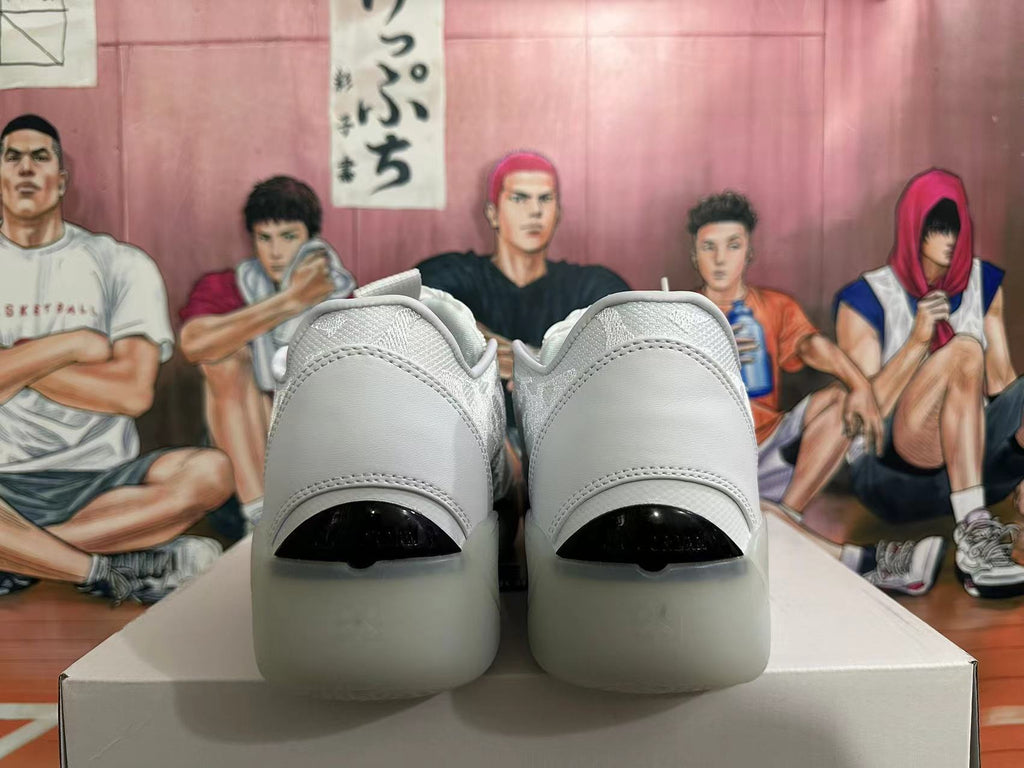Rear view of white low-top basketball shoes with dark heel details
