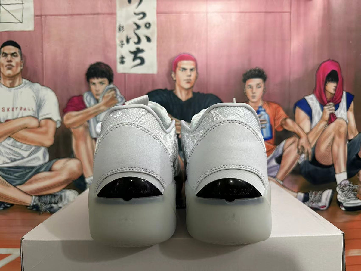 Rear view of white low-top basketball shoes with dark heel details