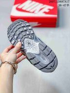 Outsole view of the gray Nike V5 RNR sneaker showing segmented tread blocks and a sculpted sole pattern.