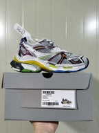 Side profile of the sneaker above its box; the box label shows Balenciaga Runner 2, style 8123, multicolor and size C 37.