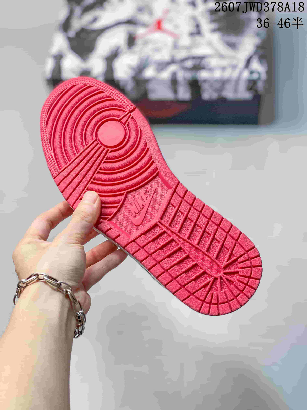 Close-up of the red rubber outsole showing circular and geometric traction patterns