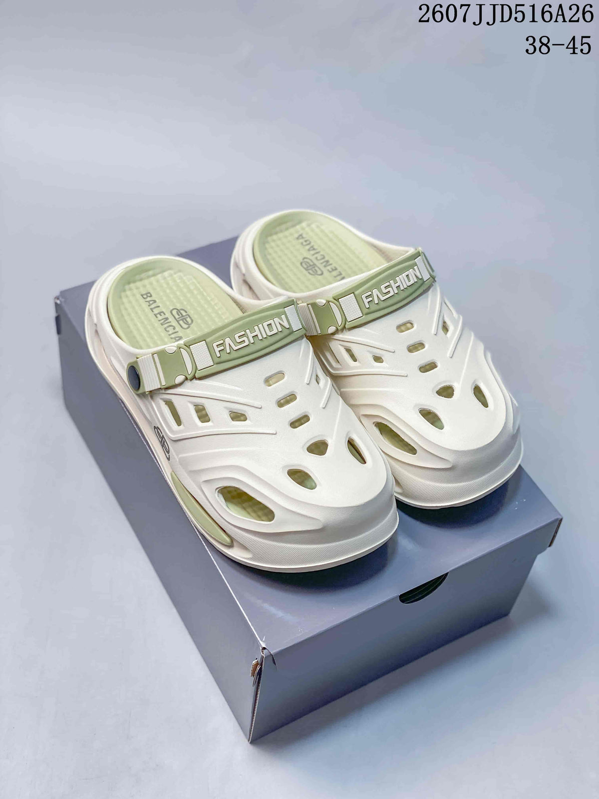 Pair of white and green platform clogs displayed on a shoe box, with the style code and size range visible above.