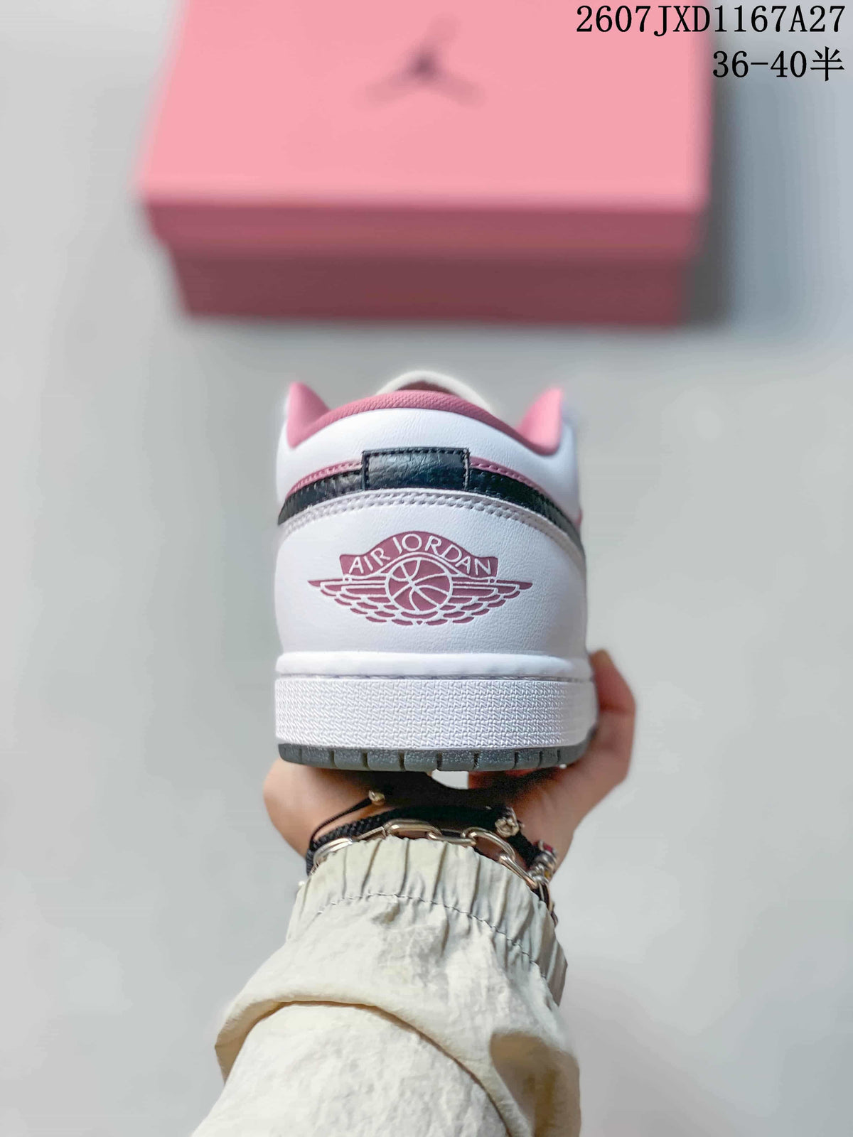 Rear view showing the Air Jordan Wings emblem, white heel, and pink collar details.
