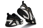 Rear and outsole views of black and white Jordan Heir shoes