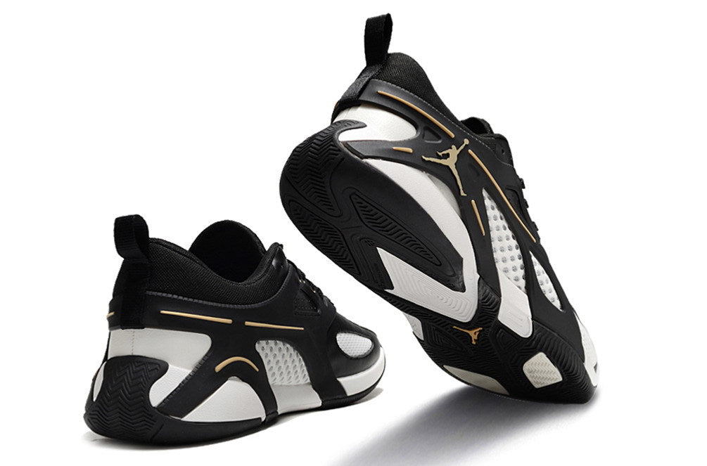 Rear and outsole views of black and white Jordan Heir shoes