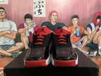 Front view showing red tongues, black laces, and glossy toe overlays
