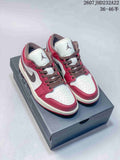 Pair of red, white, and dark brown low-top sneakers displayed on a shoebox.