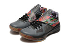 Pair of gray Nike KD 4 shoes with multicolor patterned straps and black laces.