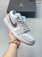 Predominantly white low-top Jordan sneaker with a taupe Swoosh and pale blue collar lining.