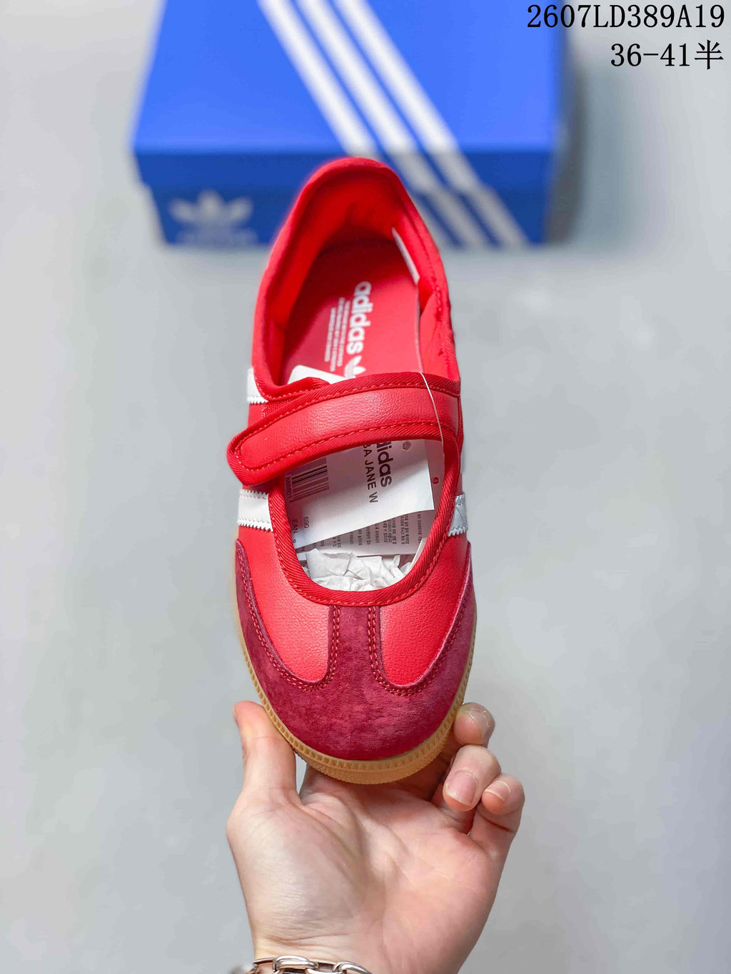Top view showing the red upper, adjustable strap, contrasting toe panel, and adidas insole branding.