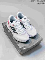 Pair of white Adidas Runfalcon 5 shoes with black side stripes and red accents on a shoe box.
