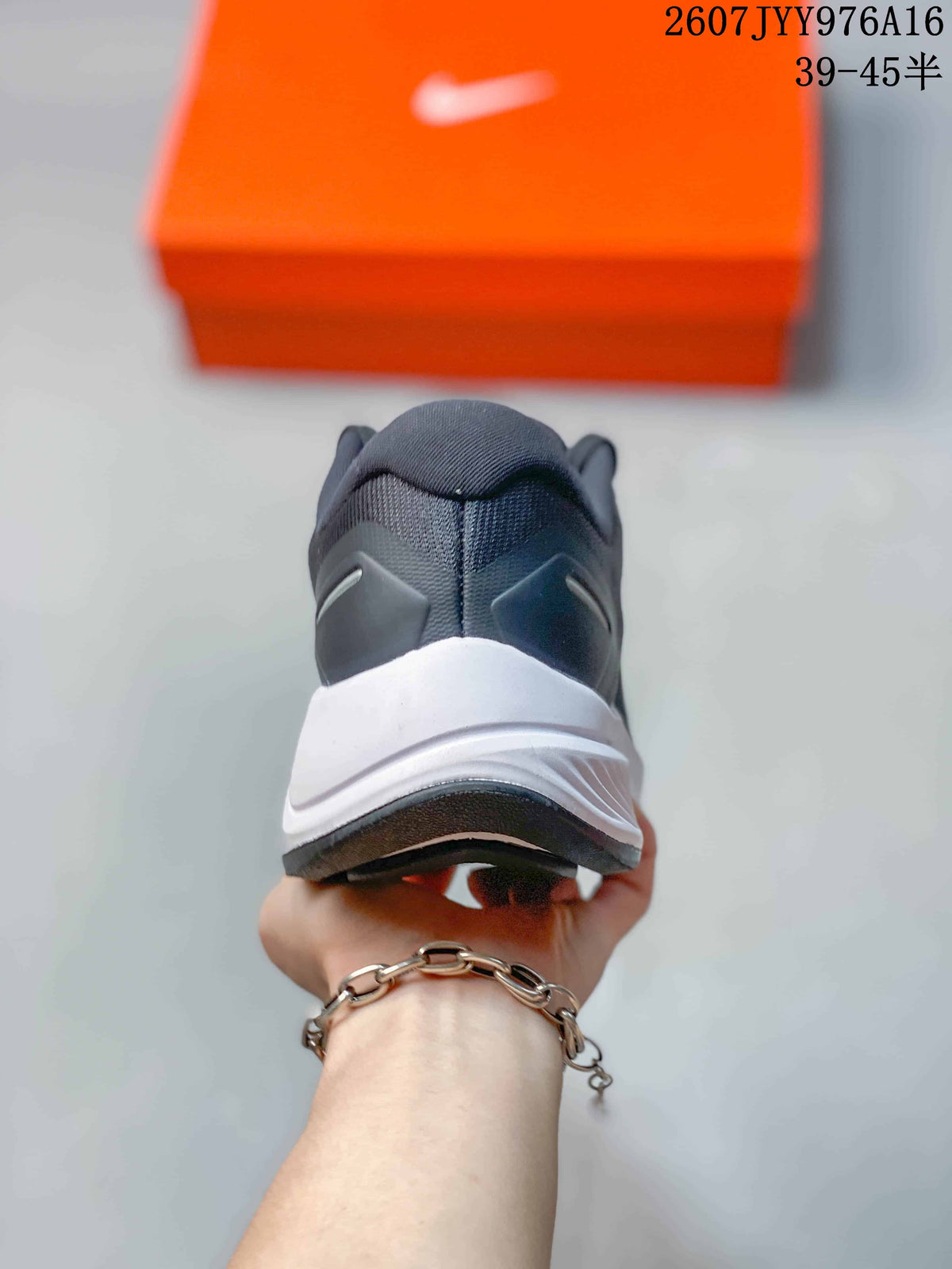 Rear view showing the padded heel collar, dark upper, white midsole, and black outsole.