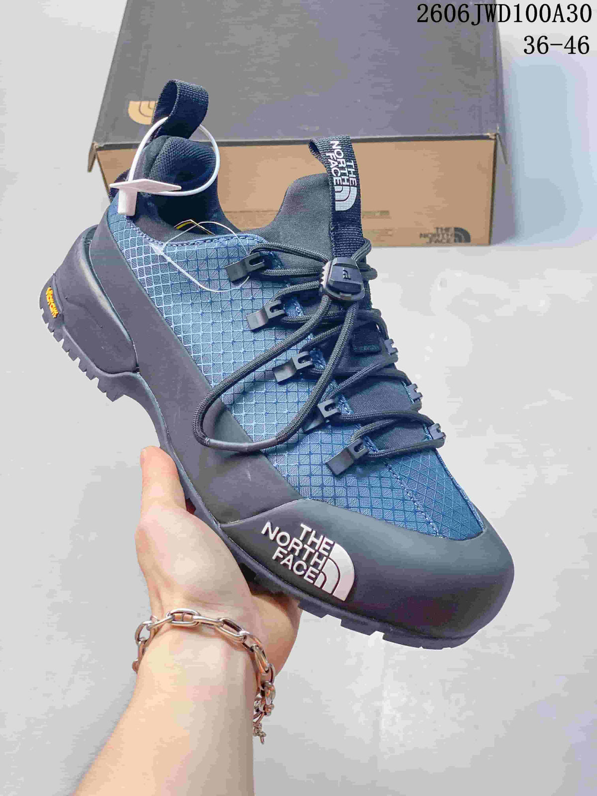 Blue and dark gray low-top The North Face Glenclyffe shoe with cord-style laces.