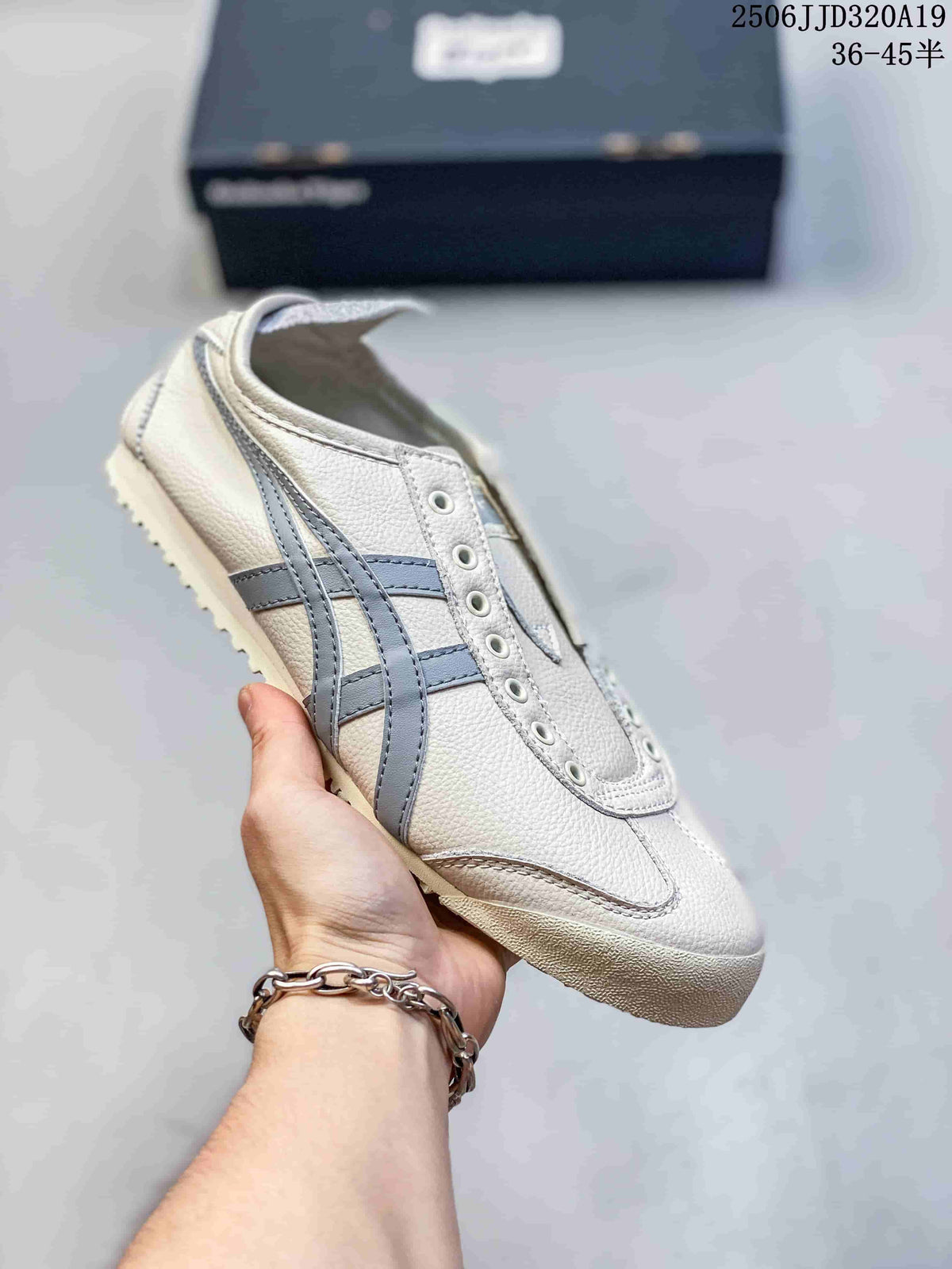 Light-colored low-top sneaker with blue-gray side stripes, shown without laces