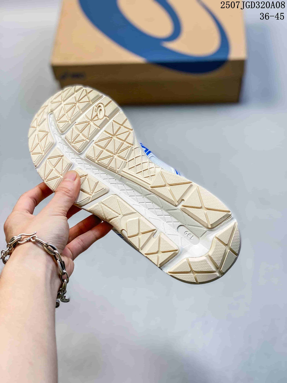 Underside view of an ASICS sneaker showing the patterned outsole tread and ASICS shoe box in the background.