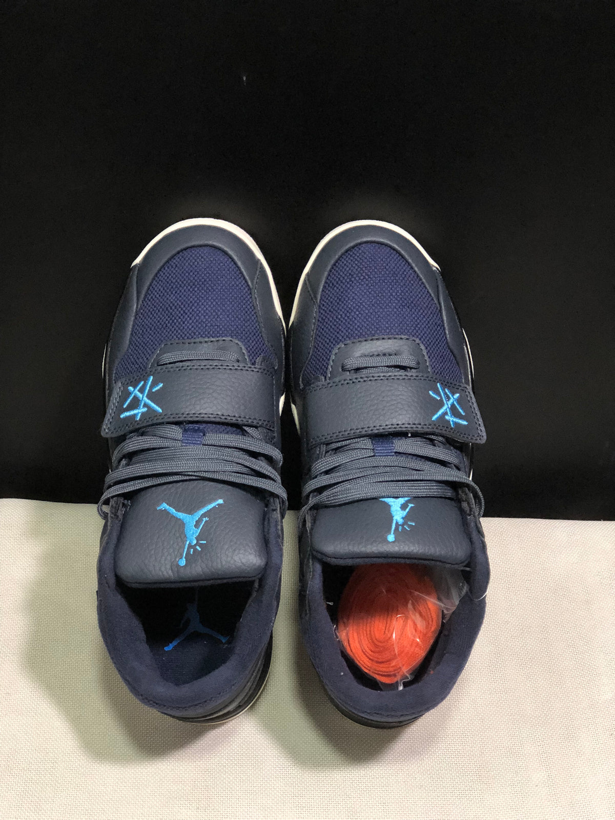 Top-down view showing the navy mesh toe areas, laces, broad forefoot straps, and blue branding.