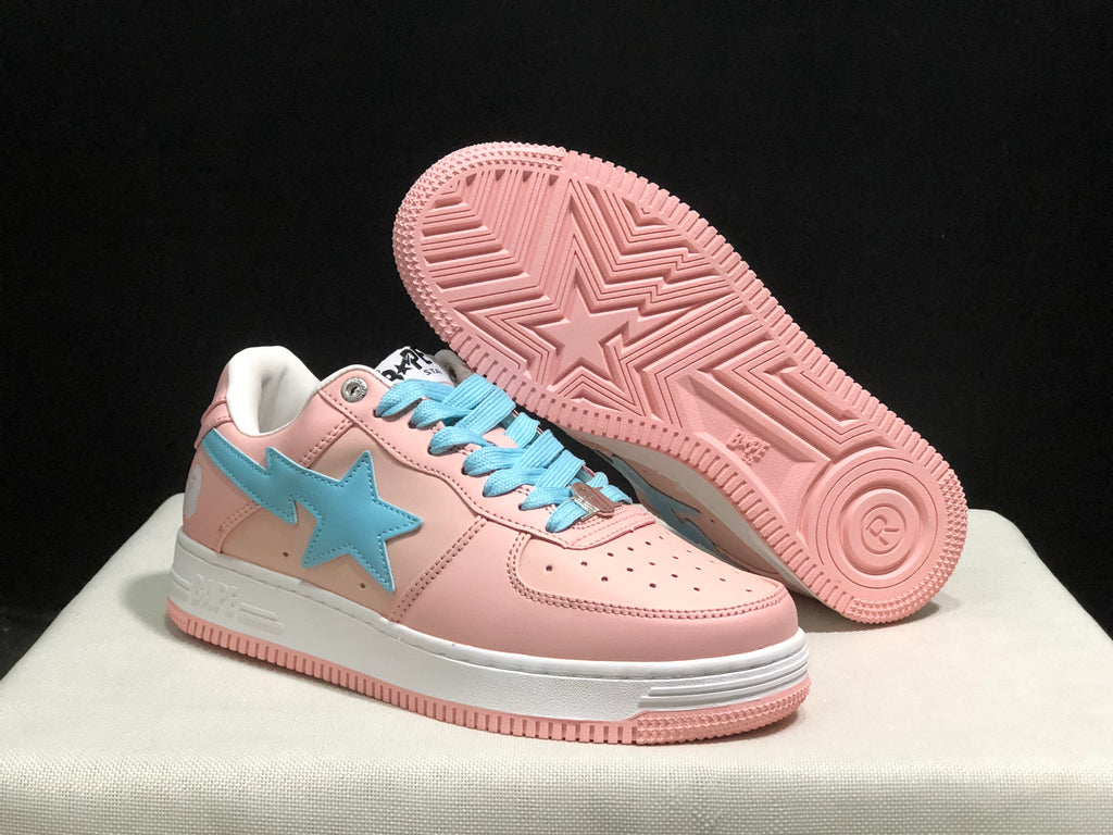 Angled underside view showing the pink rubber outsole with geometric tread and a central star motif.