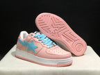 Angled underside view showing the pink rubber outsole with geometric tread and a central star motif.