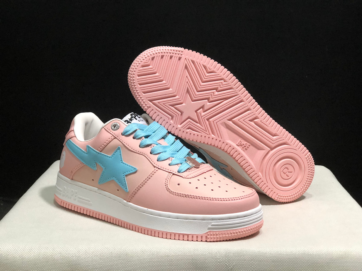 Angled underside view showing the pink rubber outsole with geometric tread and a central star motif.