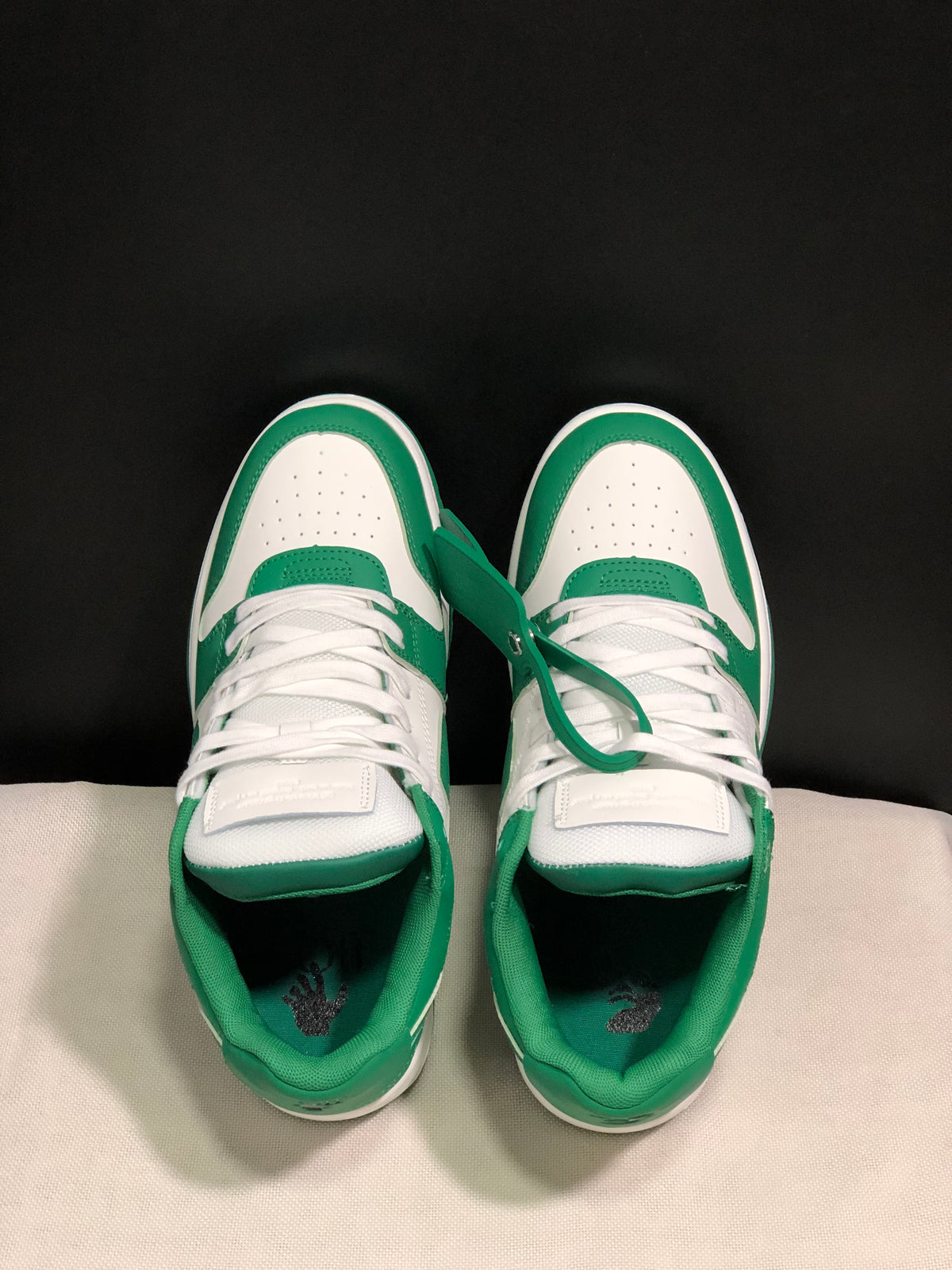 Top view showing white laces, perforated white toe boxes and green overlays.
