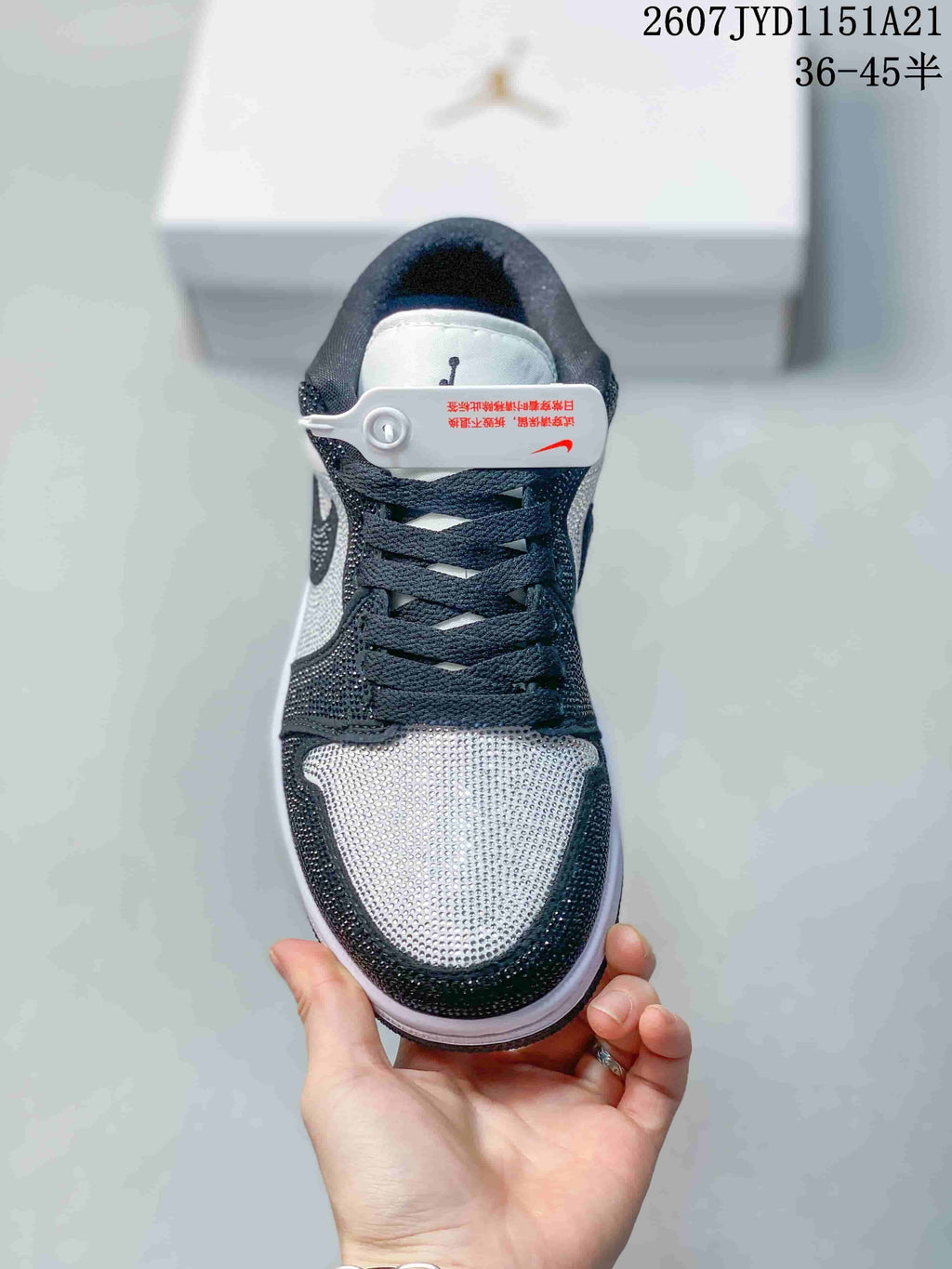 Top view showing the studded toe box, black laces, tongue branding, and contrasting black and white panels.