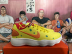 Side profile of a yellow sneaker with green dot accents, an orange Swoosh, orange heel panel, and white outsole.