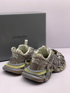 Rear three-quarter product view highlighting the heel panels, pull tabs, layered upper, and outsole.