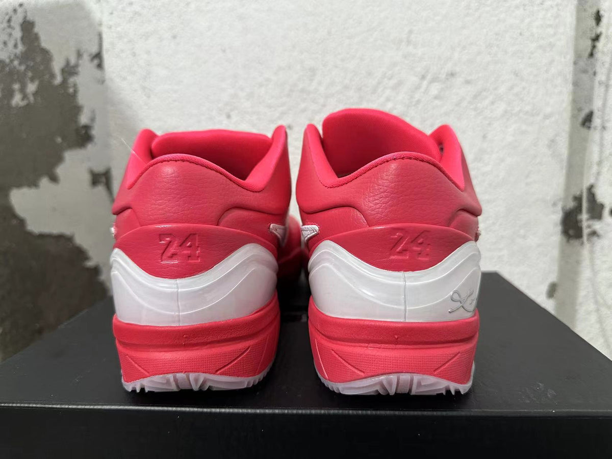 Rear view of vivid pink Nike Kobe basketball shoes with white heel accents.