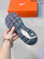 Close-up of the textured dark outsole and tread pattern of a Nike Initiator sneaker.