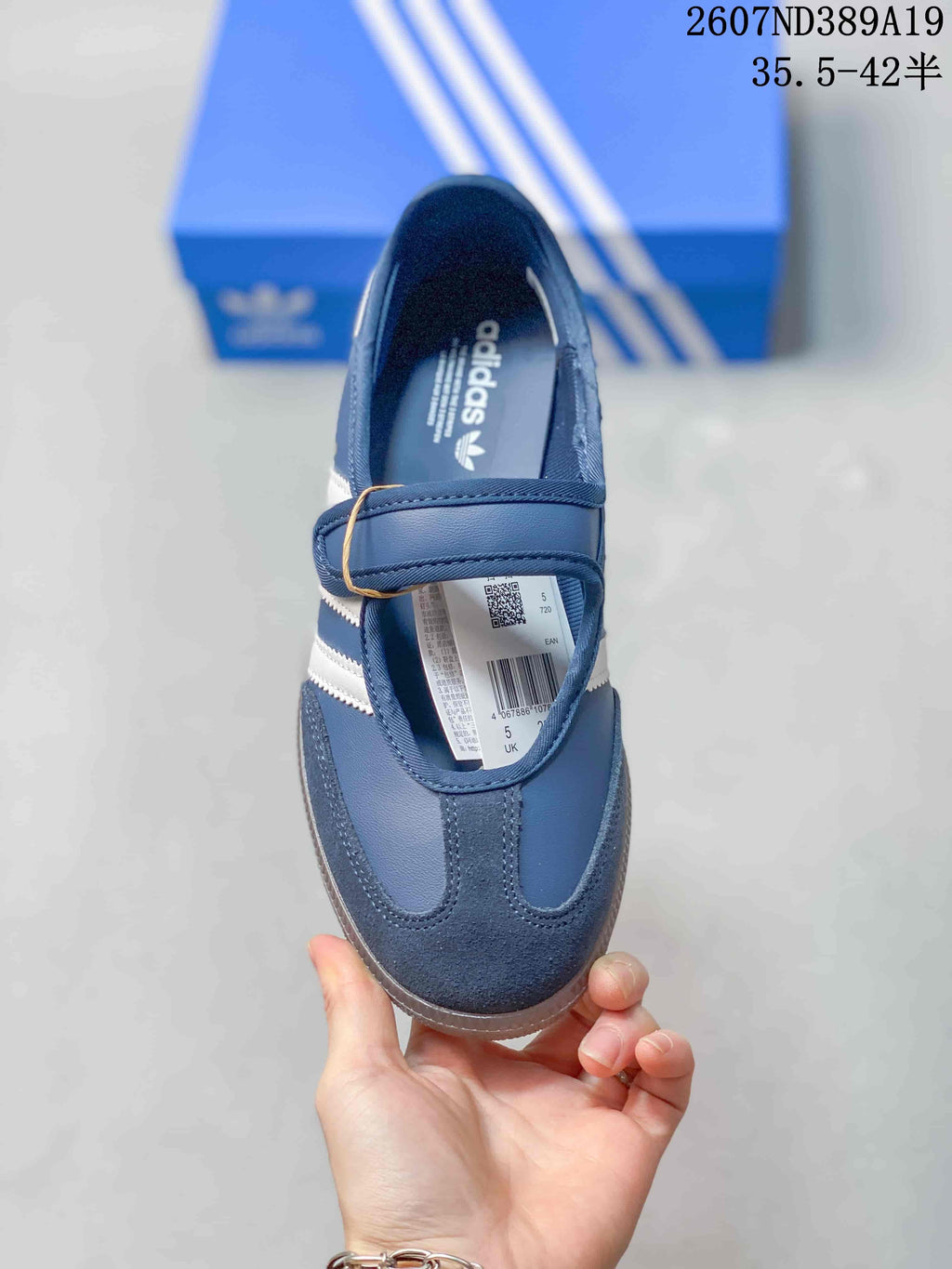 Top view of the blue sneaker showing the Mary Jane-style strap, toe overlay, interior branding, and product label.