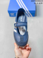 Top view of the blue sneaker showing the Mary Jane-style strap, toe overlay, interior branding, and product label.