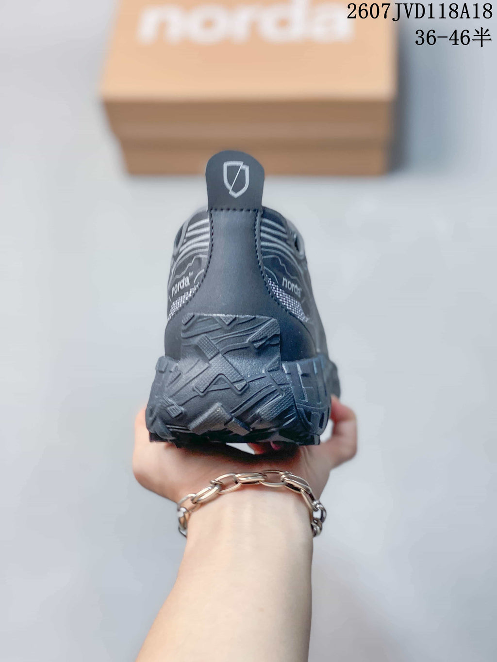 Rear view of the gray hiking sneaker showing the heel pull tab, layered heel construction, and textured outsole.