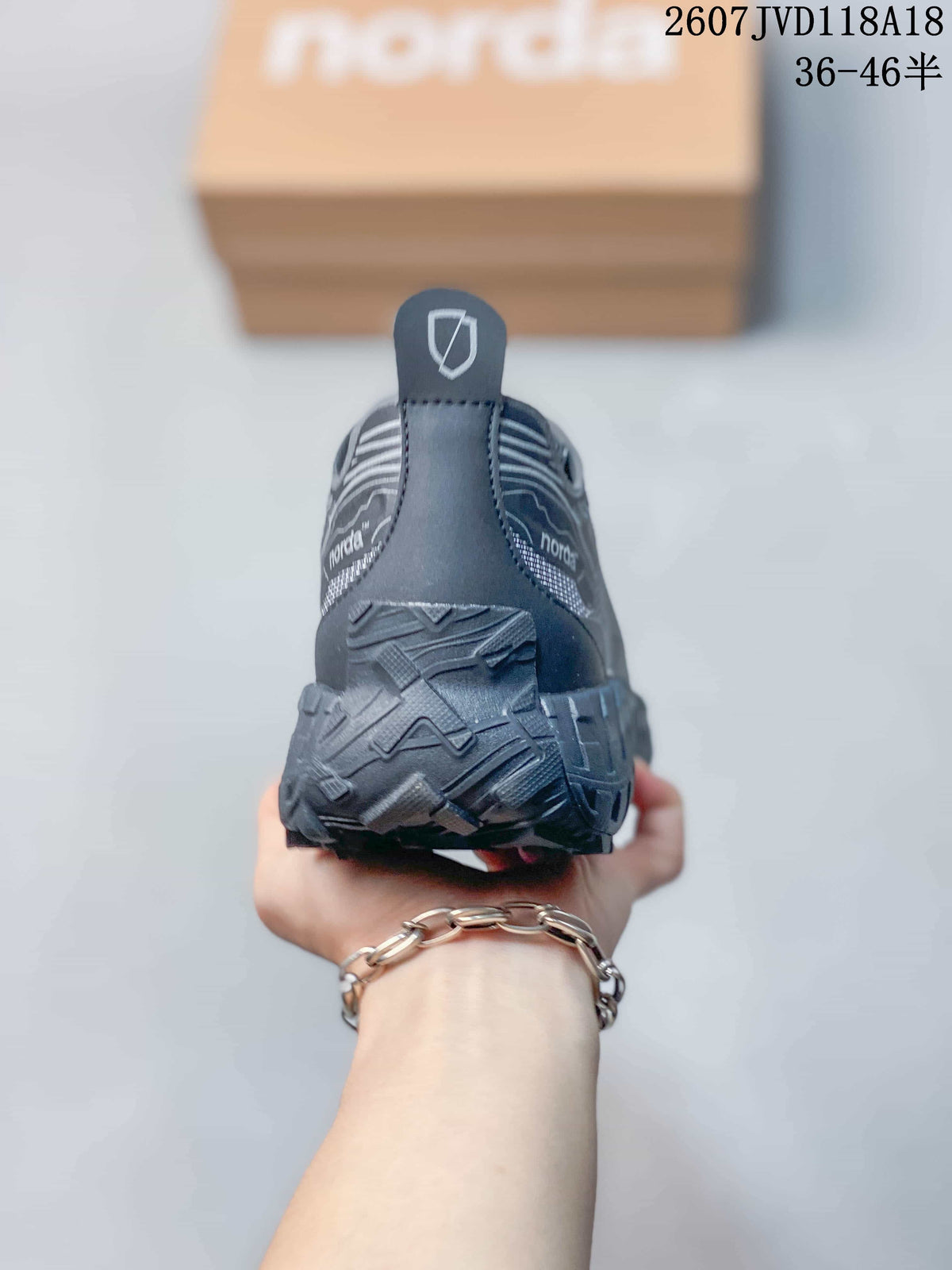 Rear view of the gray hiking sneaker showing the heel pull tab, layered heel construction, and textured outsole.