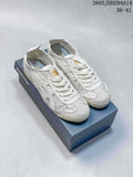 White and grey Onitsuka Tiger low-top sneakers displayed on a branded shoebox, with style code 2605 JDD294A14 and size range 36–41 visible.