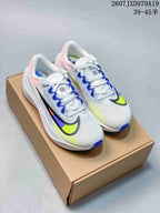 Pair of white Nike Zoom Fly 5 PRM running shoes with blue and neon yellow accents resting on a cardboard shoe box.