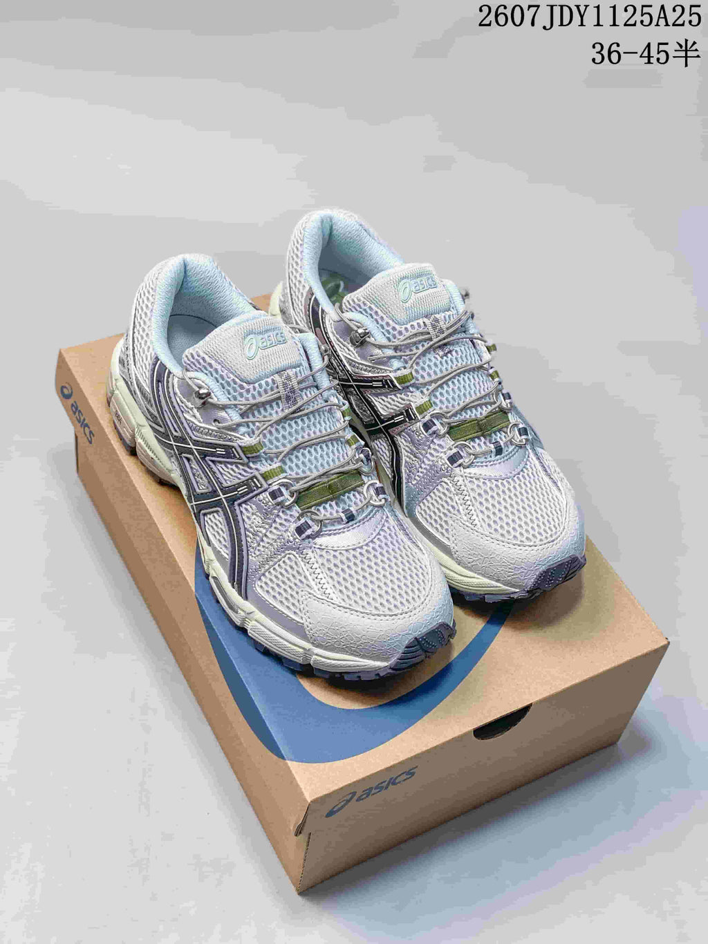 Pair of ASICS Gel-Kahana 8 FL sneakers in light grey and white displayed on an ASICS shoe box; image text shows style code 1125A25 and size range 36–45.