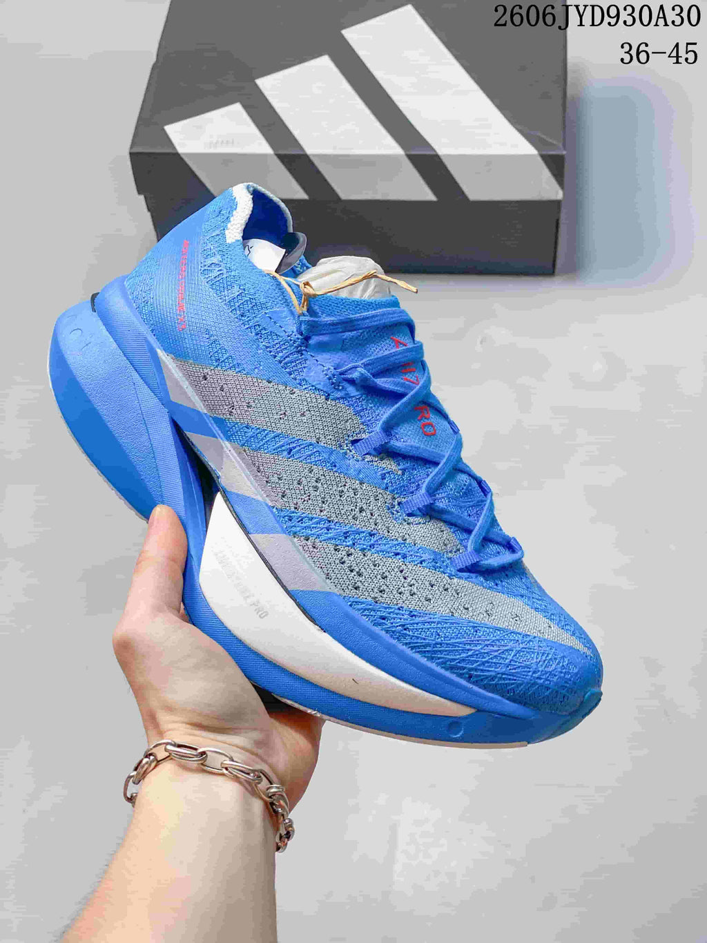 Blue adidas Adizero Prime X3 shoe with gray side stripes.