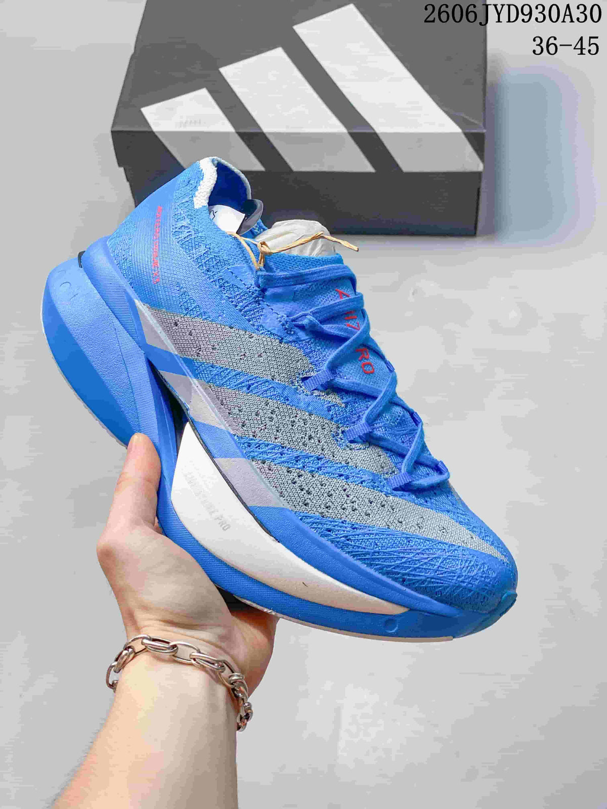 Blue adidas Adizero Prime X3 shoe with gray side stripes.