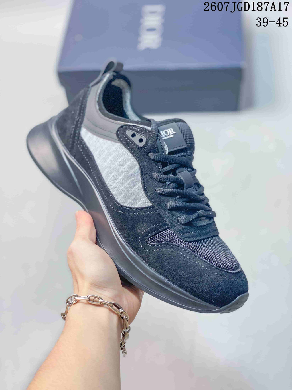Black and gray Dior B25 Runner sneaker with a dark sculpted outsole and textured side panel.
