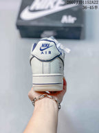 Rear view of the white sneaker showing the Nike Air heel label, layered heel panel and blue collar lining.