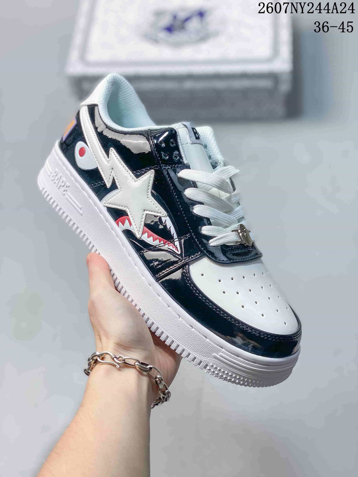 Black and white low-top sneaker with shark-mouth side artwork and white star graphic; source overlay shows style code 2607NY244A24 and size range 36–45.