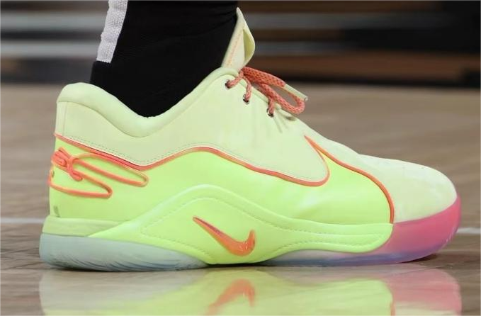 Side view of a neon green Nike LeBron 22 basketball shoe with coral accents and a high-top lace-up design.