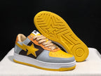 Angled view showing one sneaker's yellow patterned outsole and the side star detail.