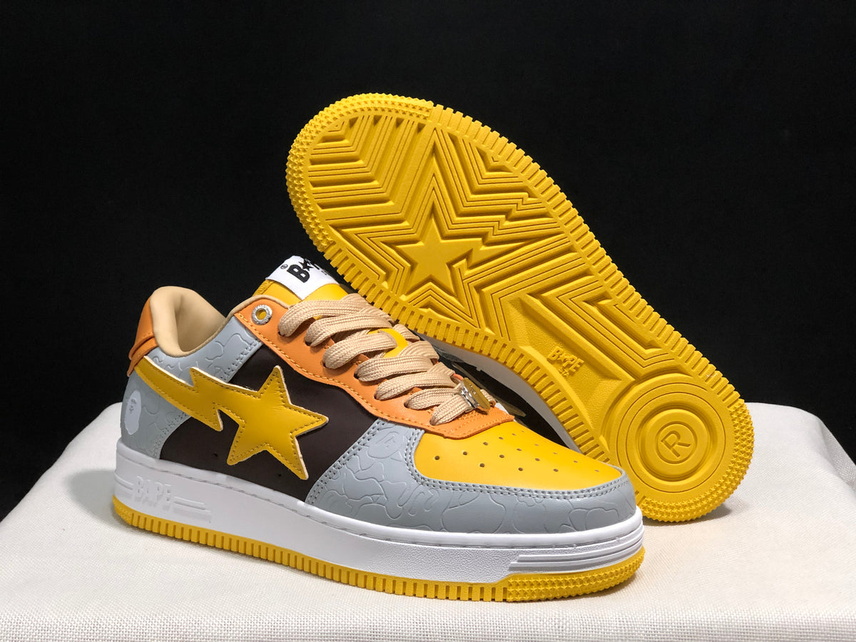Angled view showing one sneaker's yellow patterned outsole and the side star detail.