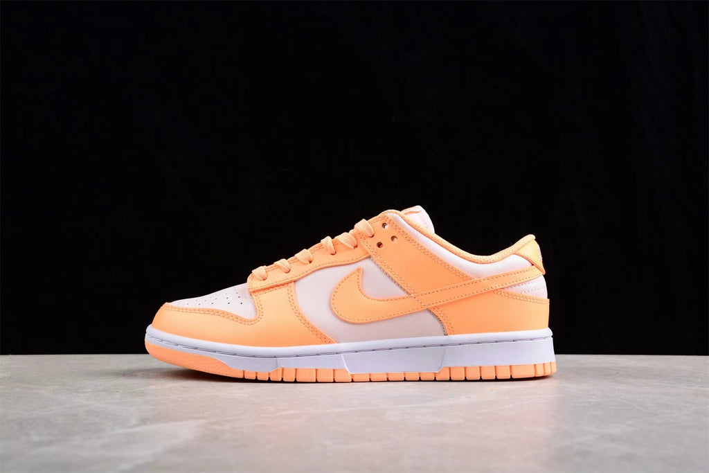 Opposite side profile showing the low-top shape, orange and light gray panels, and layered sole.