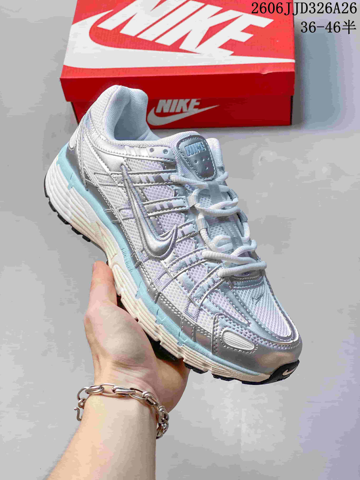 Angled view of a silver and white Nike P-6000 sneaker with pale blue accents