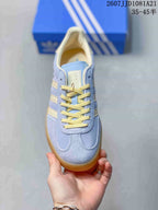 Top view of a light blue sneaker with cream detailing and yellow laces.